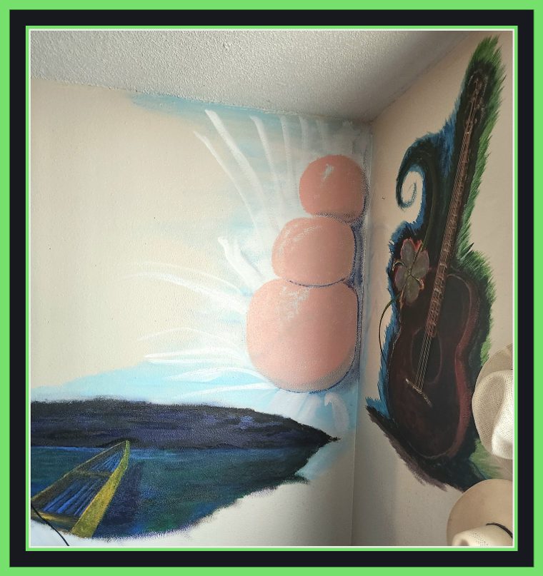 Early stage of the wraparound corner mural: a boat out on dark night water, a pale blue burst of light, three floating peach-toned orbs, and a guitar wrapped in blue-green foliage on the adjoining wall. The water and night sky are still bare ground at this stage.